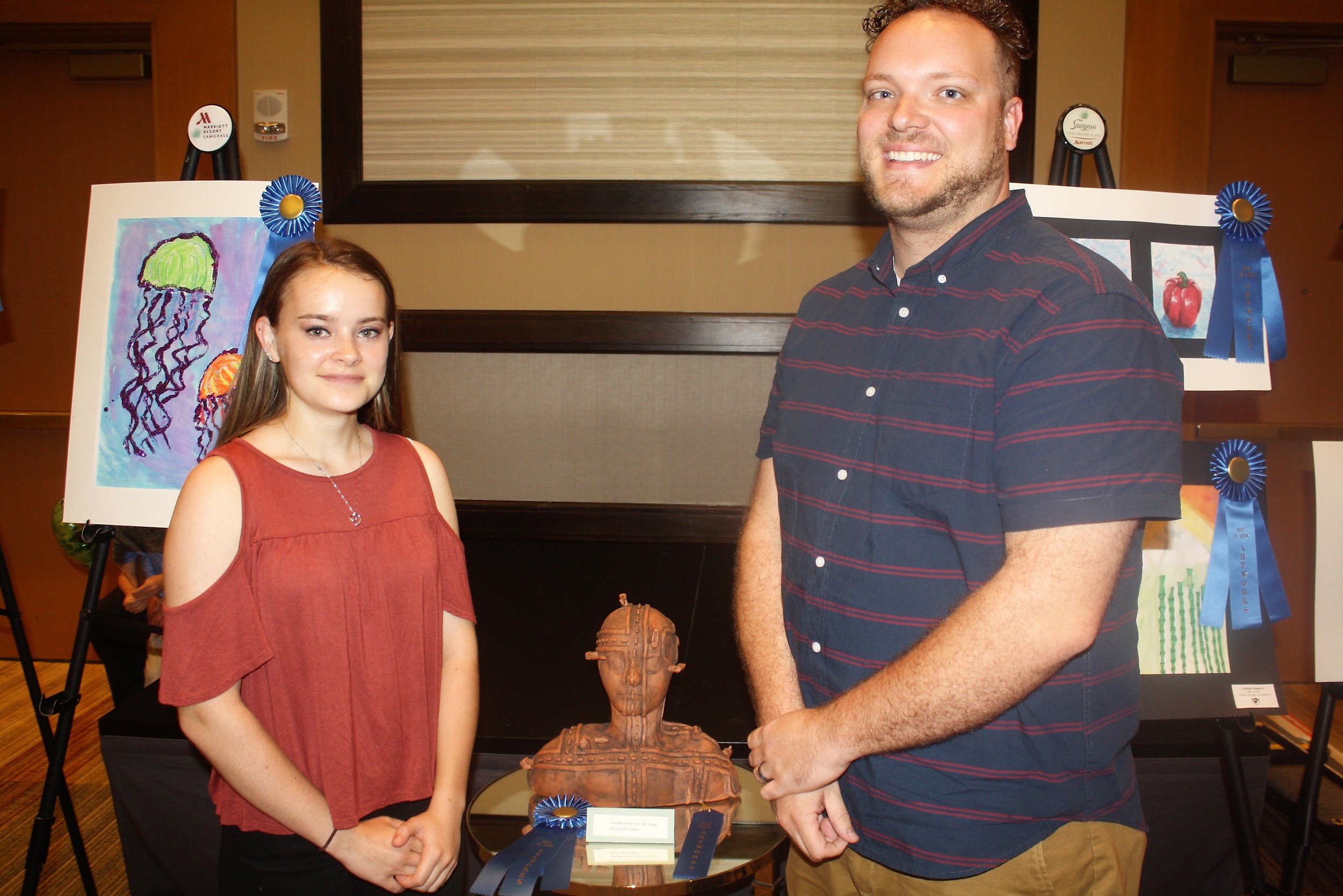 Nease High School student Amanda Yurkovich and teacher David Maynard stand with her prizewinning sculpture