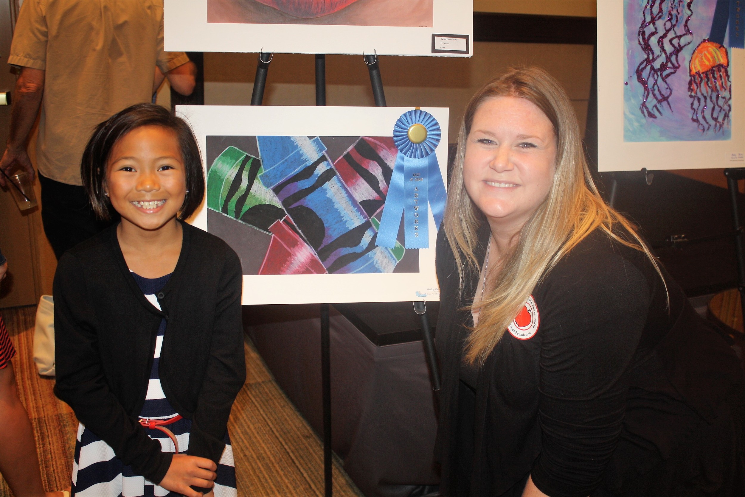 Ocean Palms student Maddy Clemons displays her Best of Show artwork with teacher Lauren Rodriguez