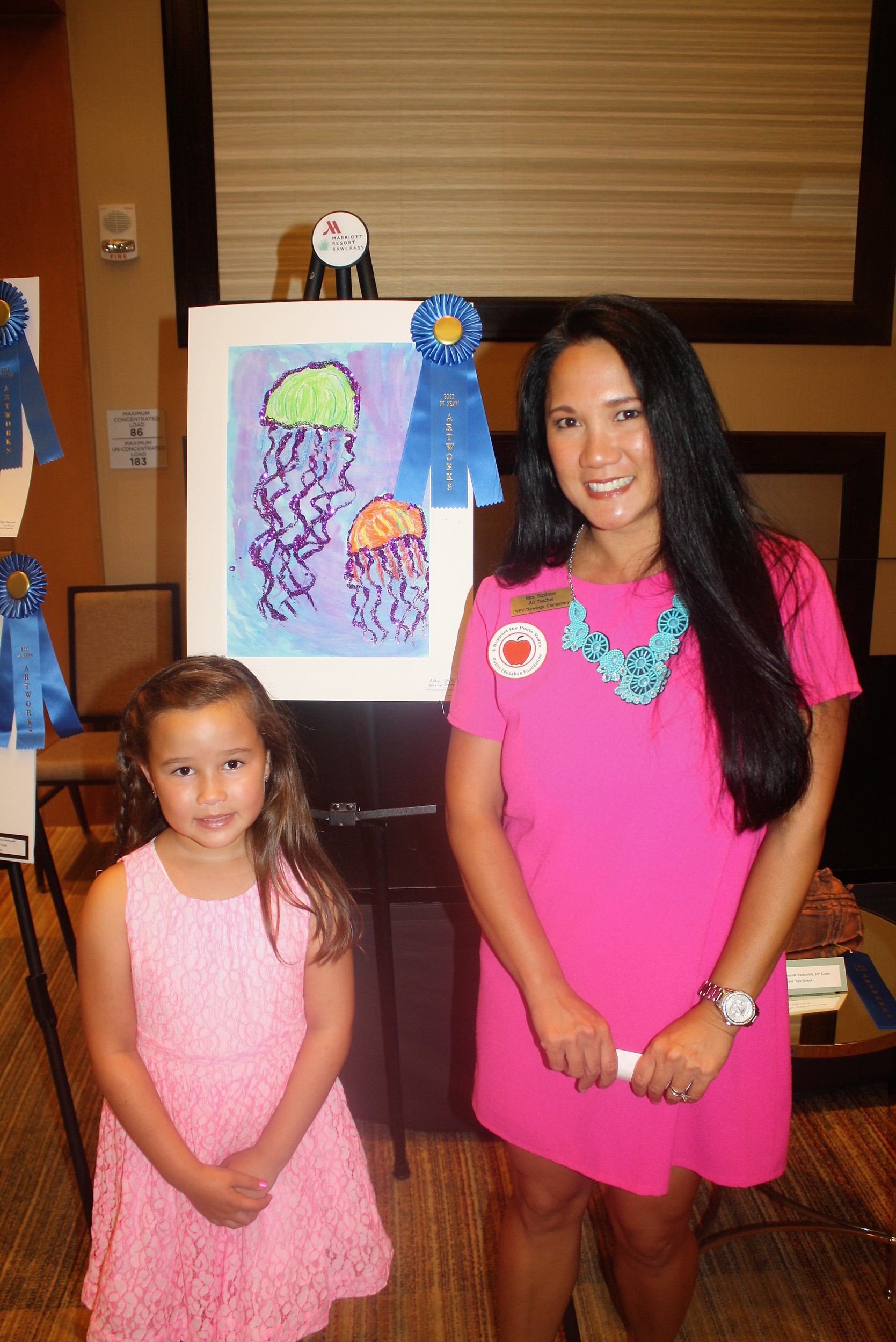 PVPV Rawlings second grade student Abby Shin displays her artwork with art teacher Kimberly Scribner