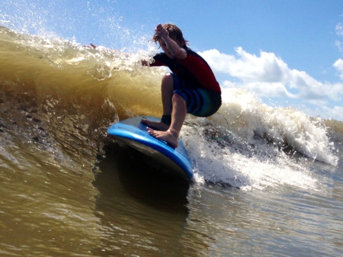 A camper at Surf Into Summer Surf Camp charges a wave.