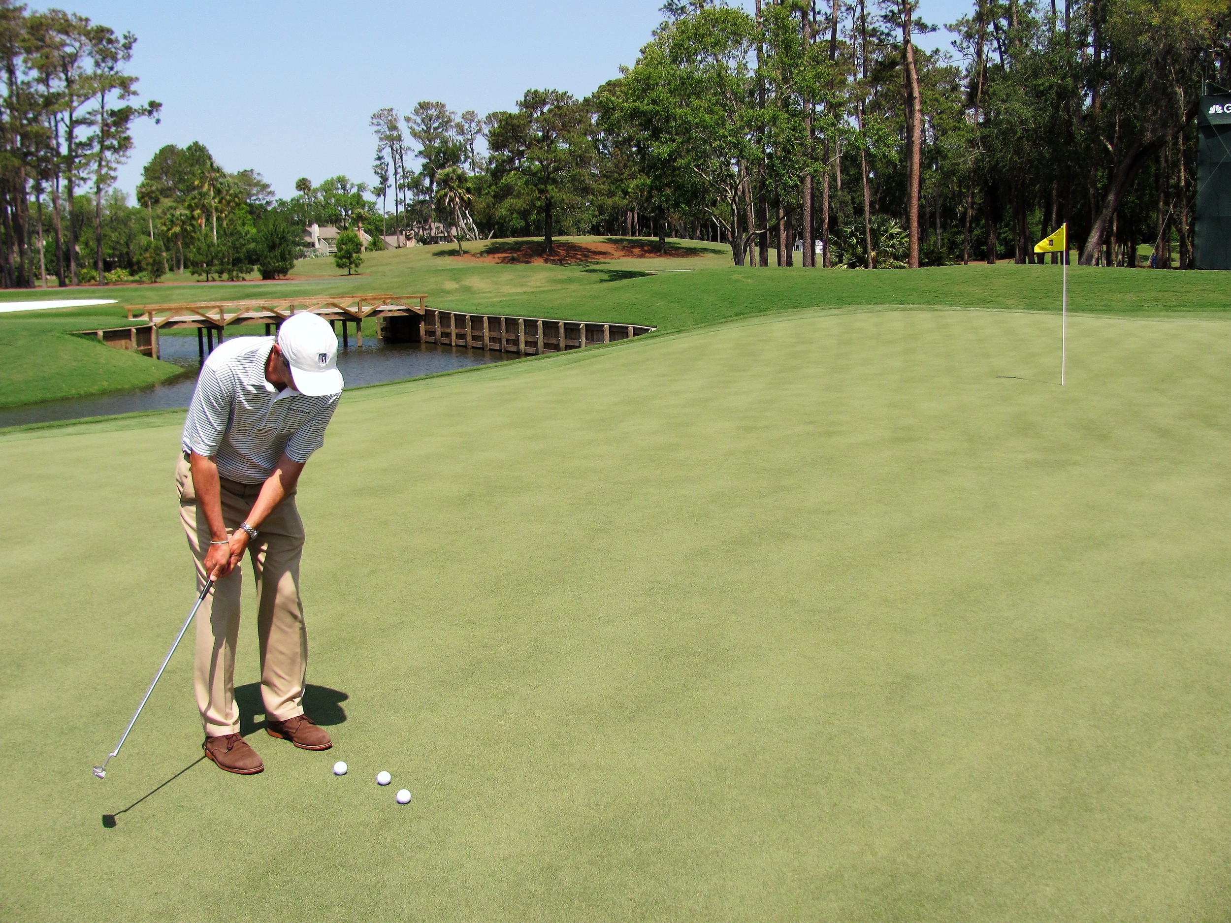 Stephen Cox sets a hole location at TPC Sawgrass.