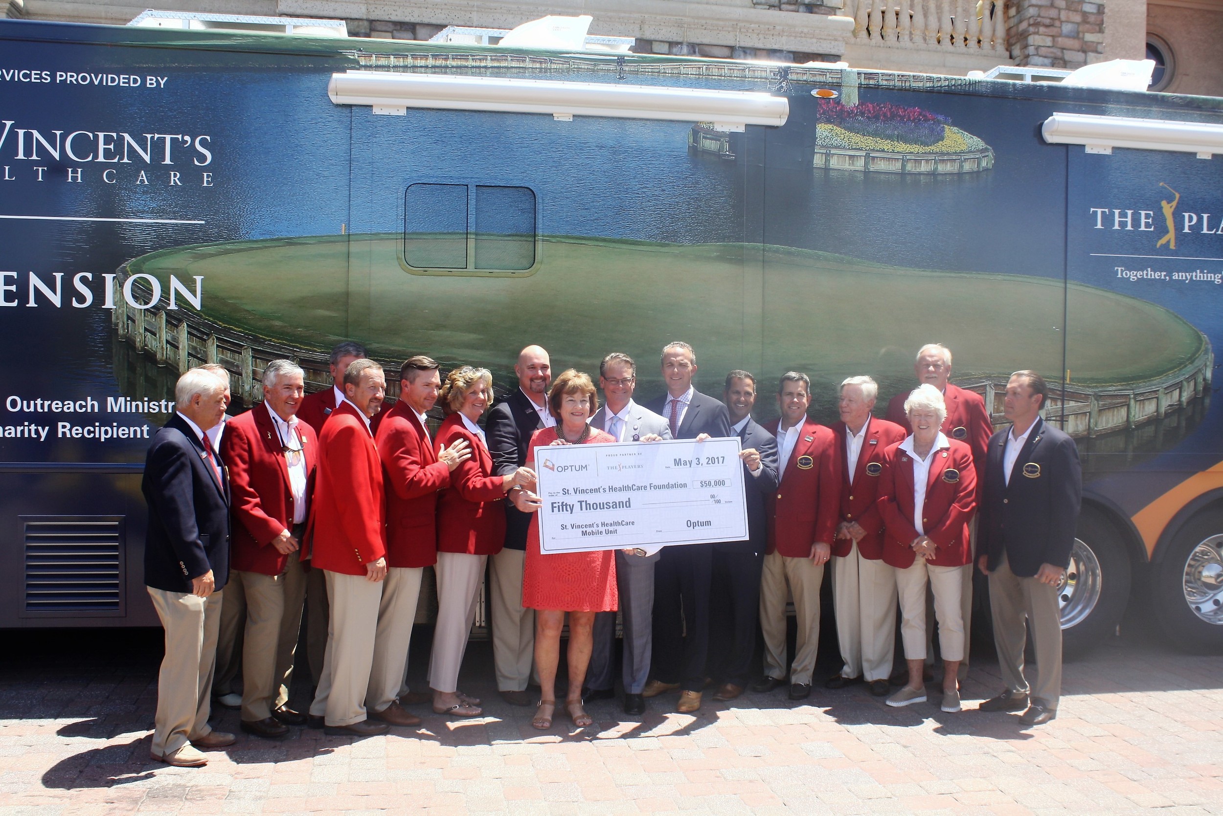 Representatives from St. Vincent’s HealthCare join with THE PLAYERS Championship officials to accept the donation of a new mobile health unit.