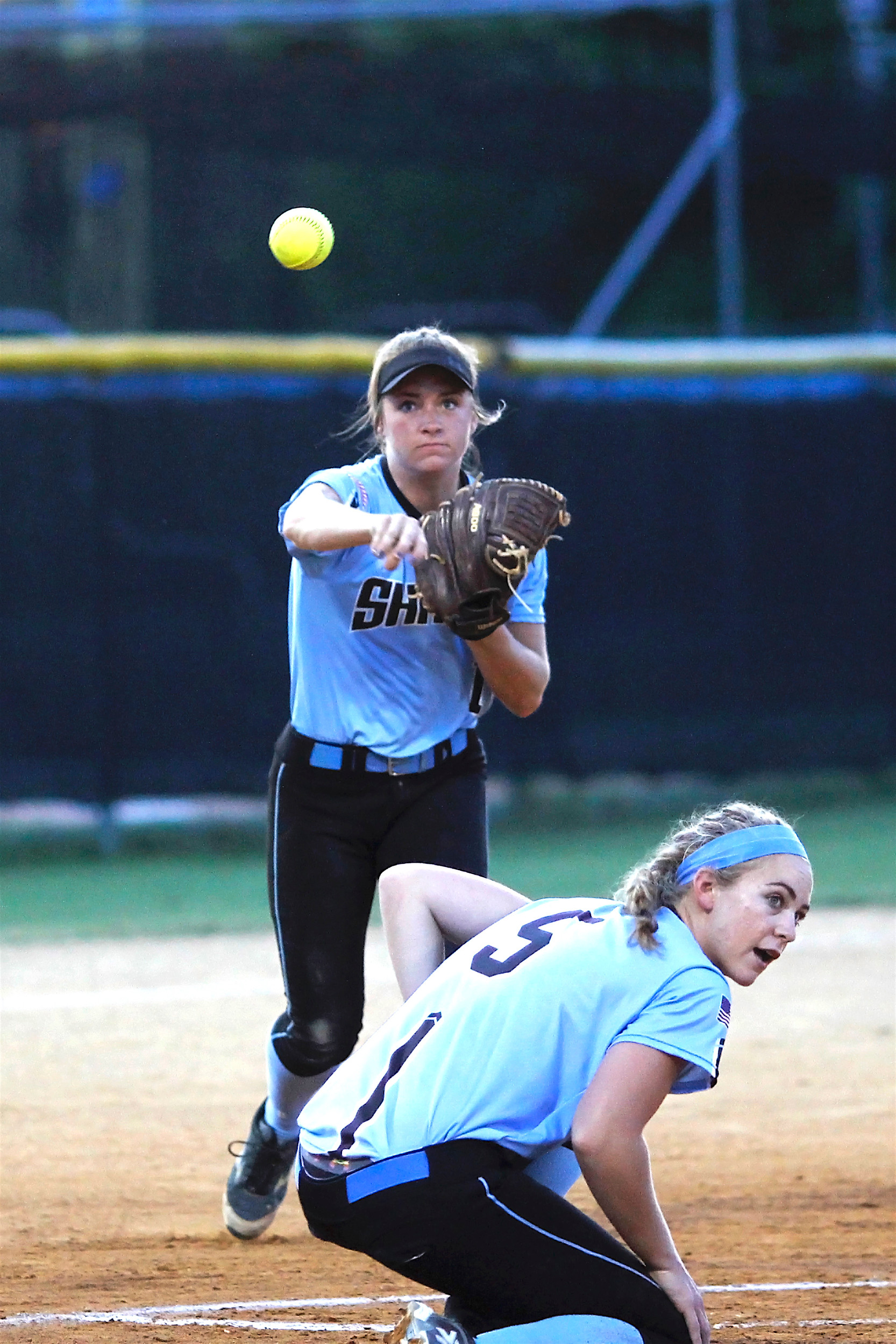 Bailey Wagoner fires to first to nip the Parker batter on an attempted bunt as Shark pitcher, #5 Michelle Holder ducks out of the way.