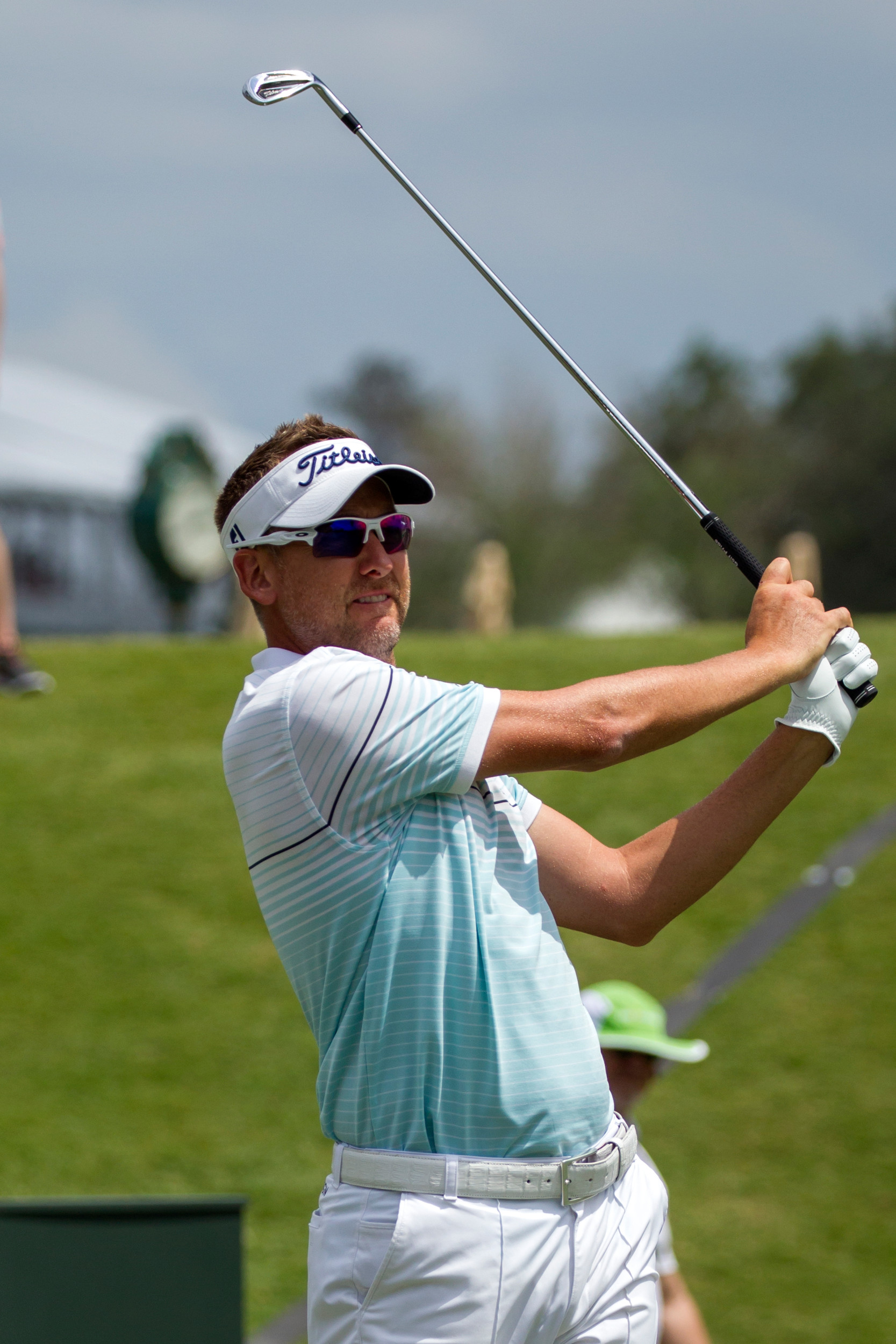 Ian Poulter of England, who tied for second with Oosthuizen, watches on as his shot sails down the fairway.