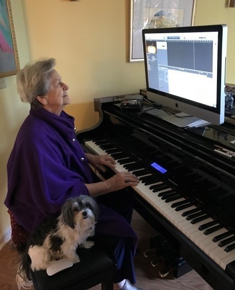 Bess Turk uses adaptive technology while playing the piano.