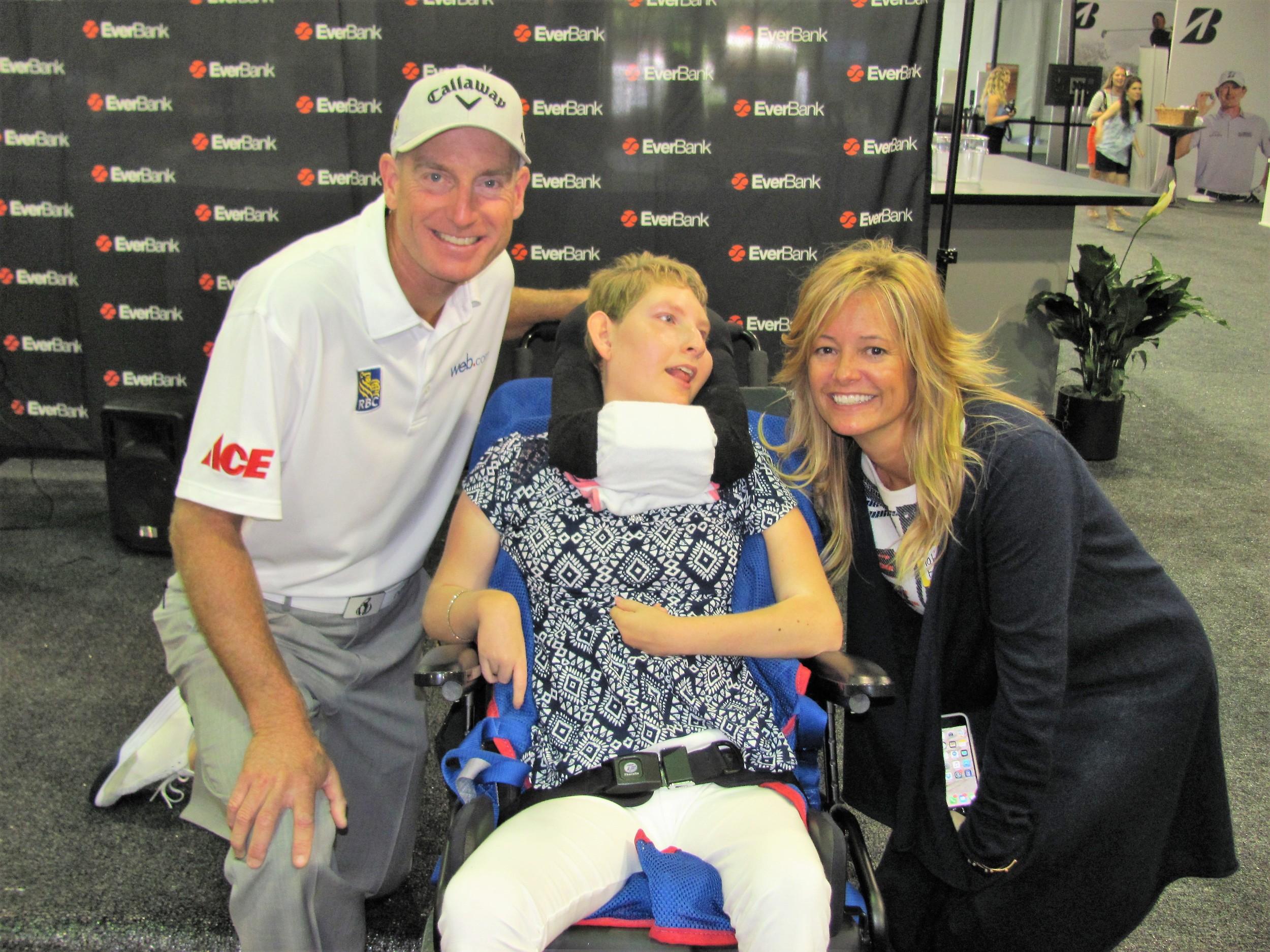 Jim and Tabitha Furyk greet one of the children from Community PedsCare.