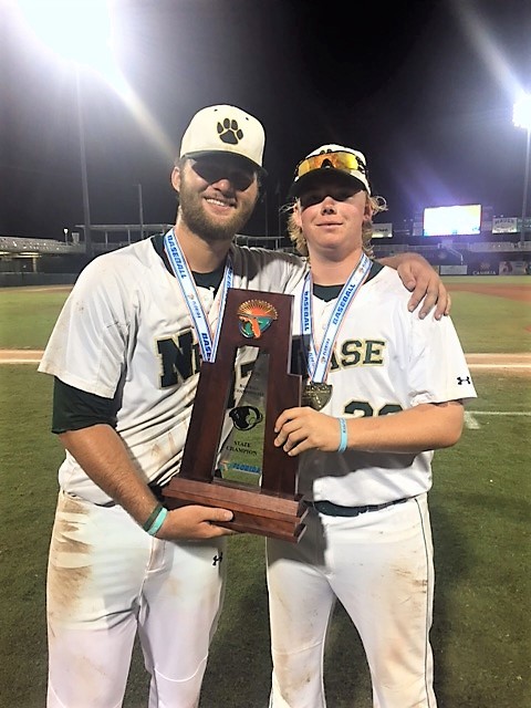 Nease pitchers Leighton Alley and Eric Linder display the state championship trophy. The Nease baseball team captured its first state title last week, defeating King High School 11-0 in the Class 7A title game.