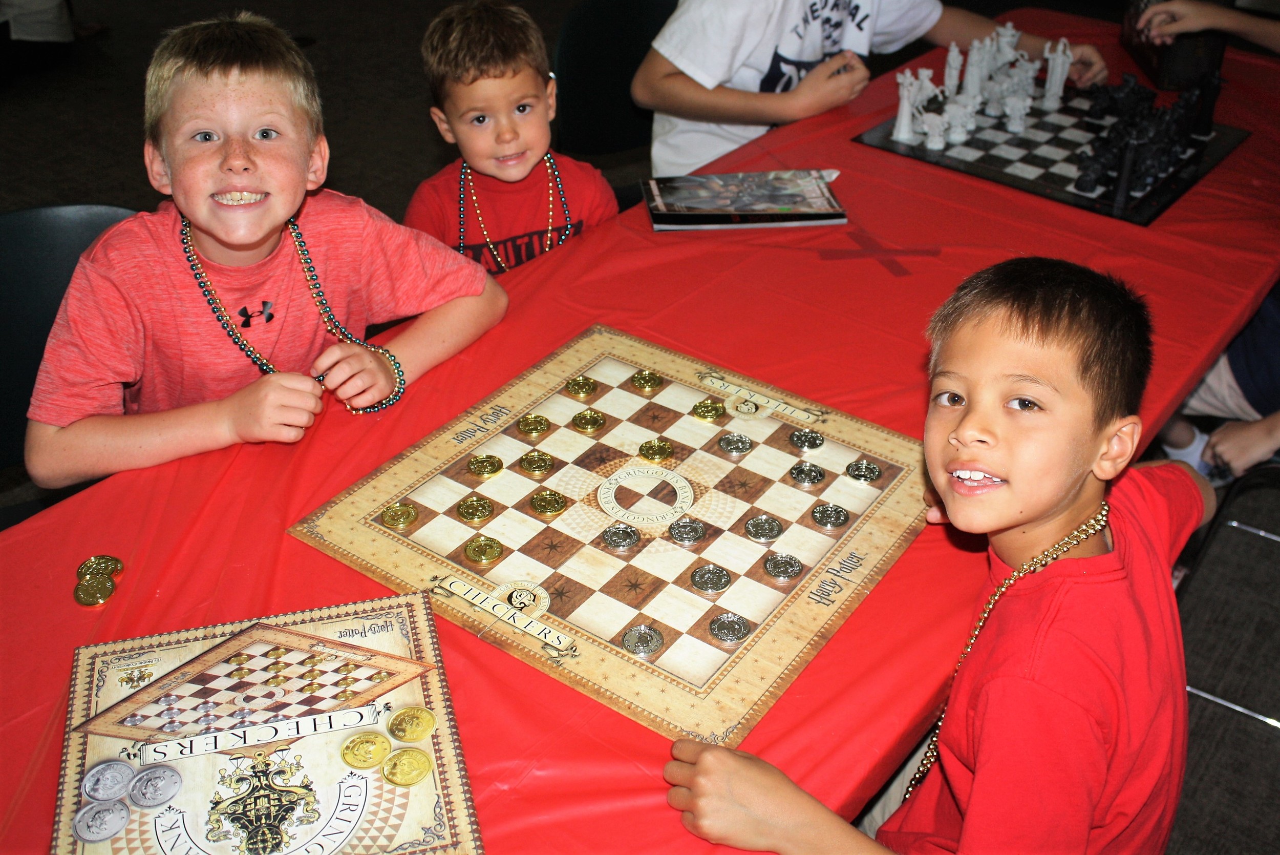 Local children play Gringotts Checkers at the library event.