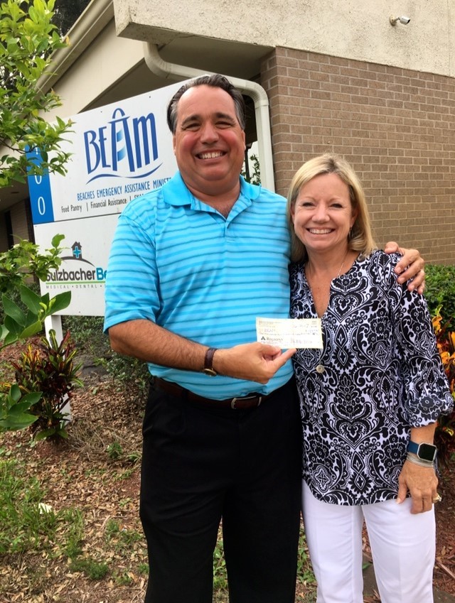 John Miller of Rock Solid Law presents the proceeds of the Second Annual Sterling’s Summer Pier Dance to Susan King, executive director of the Beaches Emergency Assistance Ministry (BEAM). The proceeds will be used to provide meals for needy students during the summer recess from school.
