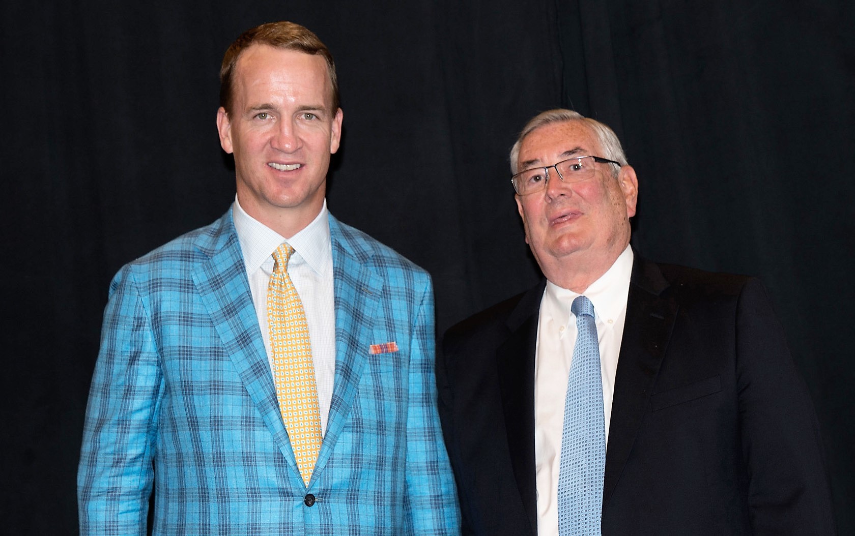 Peyton Manning, who made a special appearance, joins Lee Whittaker (right), president of MDM Healthcare, at the Premier Breakthroughs Conference Awards Ceremony.