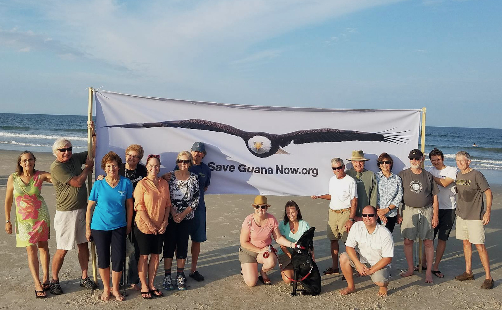 Save Guana Now members display their new banner at a meeting held July 26.