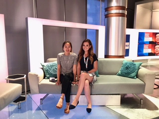 Elizabeth Bugbey (right) sits on the set of Headline News (HLN) at the CNN Center with fellow intern Haerin Jang.