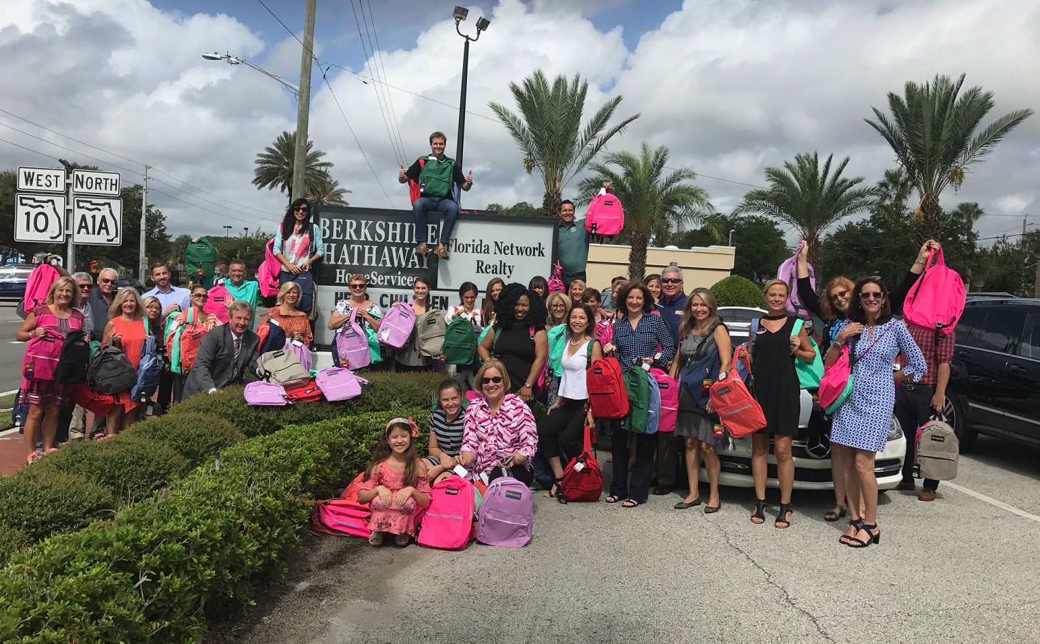 Berkshire Hathaway HomeServices Florida Network Realty employees display donated backpacks outside of the company’s office in in Atlantic Beach.