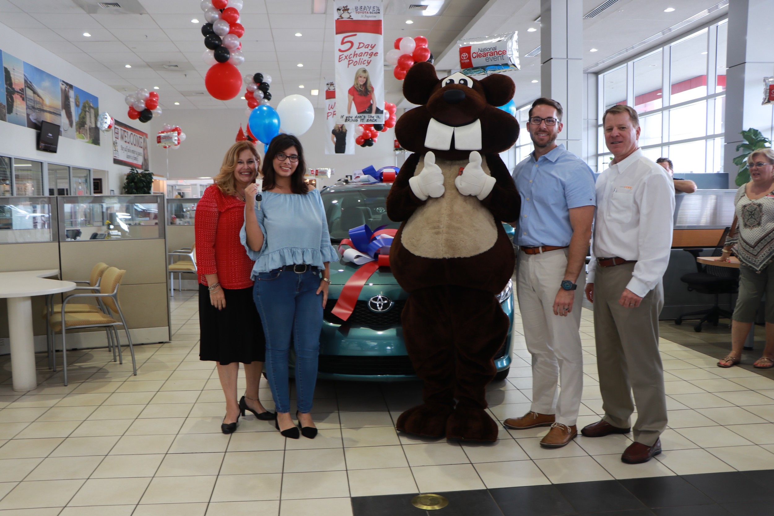 AutoPoint Florida employees join with Beaver Toyota personnel and Daniel Kids leadership to present Adelina Ferreira with a car.