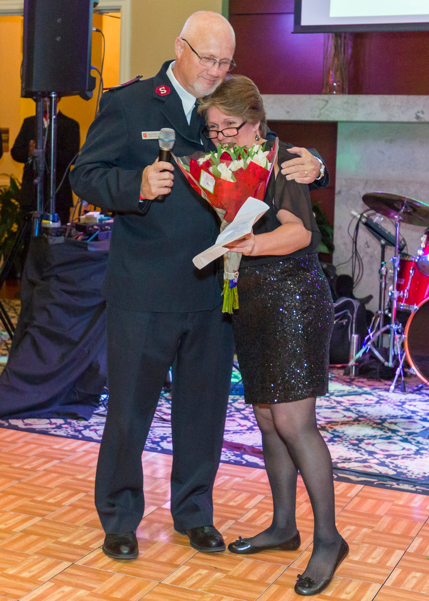 Major Rob Vincent congratulates former shelter resident Wendy Shaw at the 2016 Red Shield Ball on her success since graduating from the program.