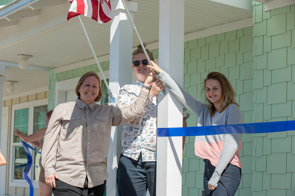 A Jacksonville Beach family celebrates their new Habitat for Humanity home, built with funds and labor from MDM.