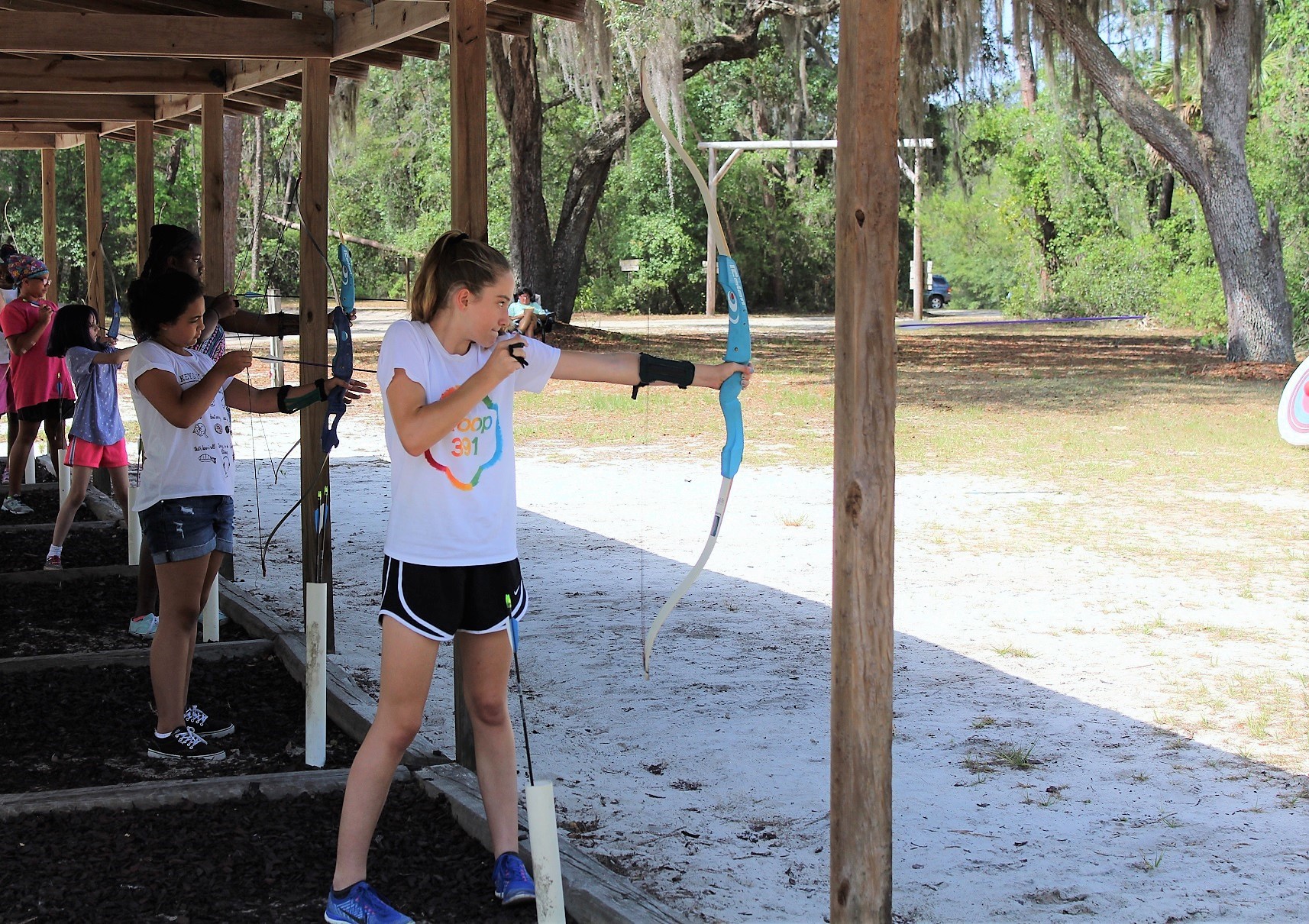 Girl Scouts fine-tune their archery skills.
