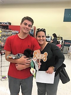 A couple adopts a dog at the event.