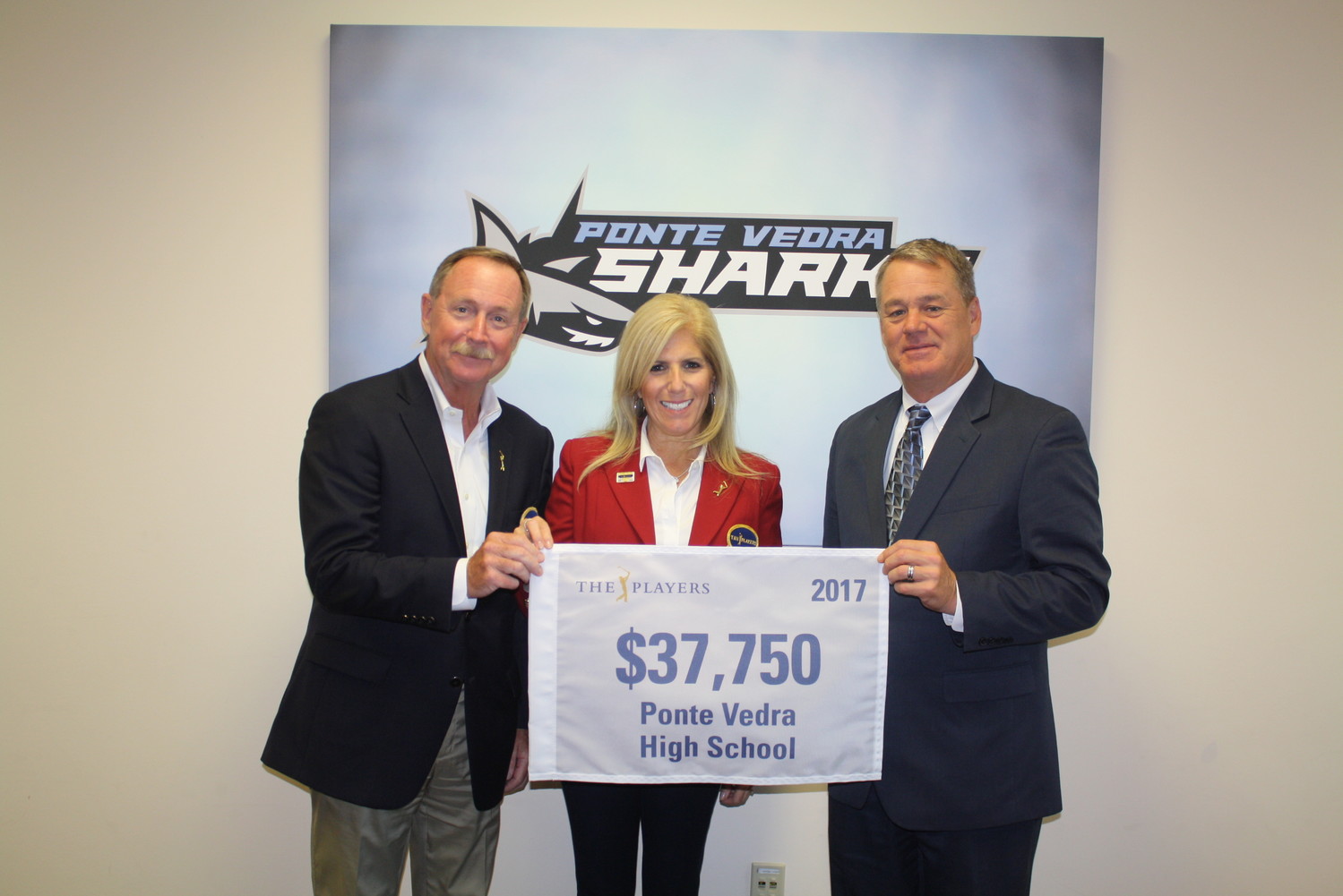 Vice-chair of Players Services Scot Winter (left) and 2016 Tournament Chairman Michele McManamon present Ponte Vedra High School Principal Fred Oberkehr with $37,750 as part of THE PLAYERS’ annual Giving Back events.