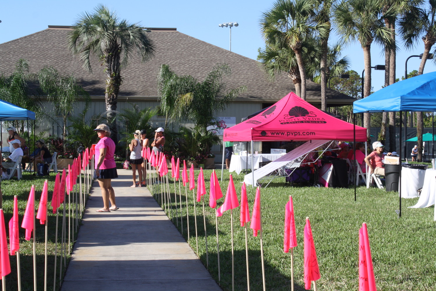 Pink flags line the walkway during the SenioRITAs tennis tournament at Sawgrass. The flags had names written on them in honor of breast cancer survivors and those lost to breast cancer.