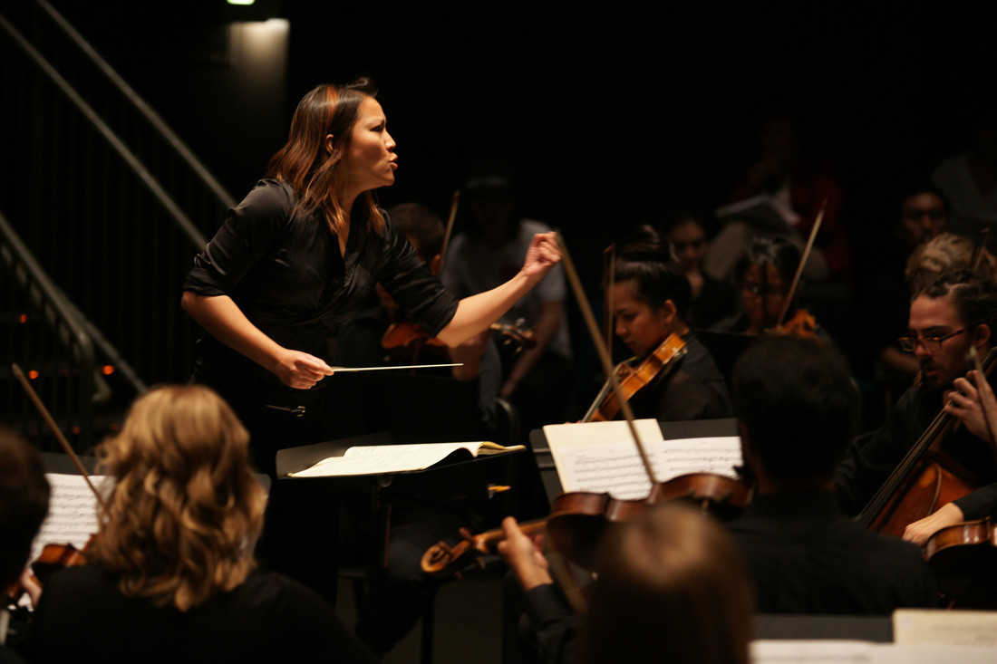 Jacksonville Symphony assistant conductor Deanna Tham leads a performance.