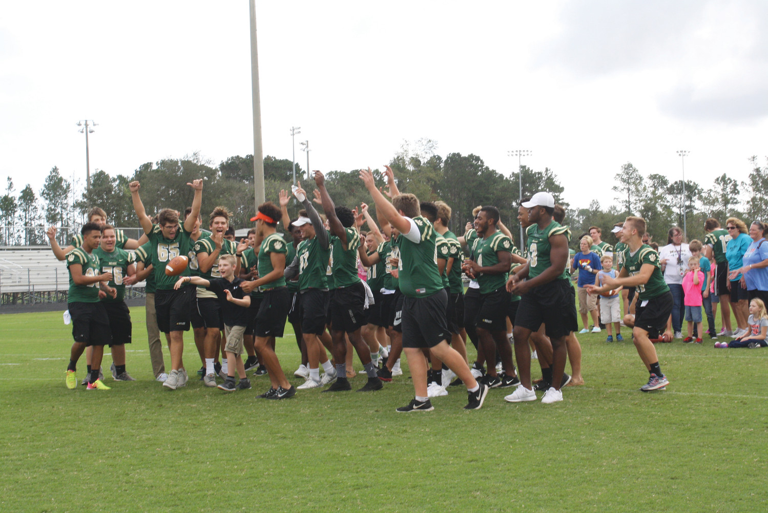 Special needs students from Valley Ridge Academy, Timberlin Creek Elementary and Wards Creek Elementary score touchdowns with the support of the Nease football team during the “Victory Day” event at Nease High School last Friday.