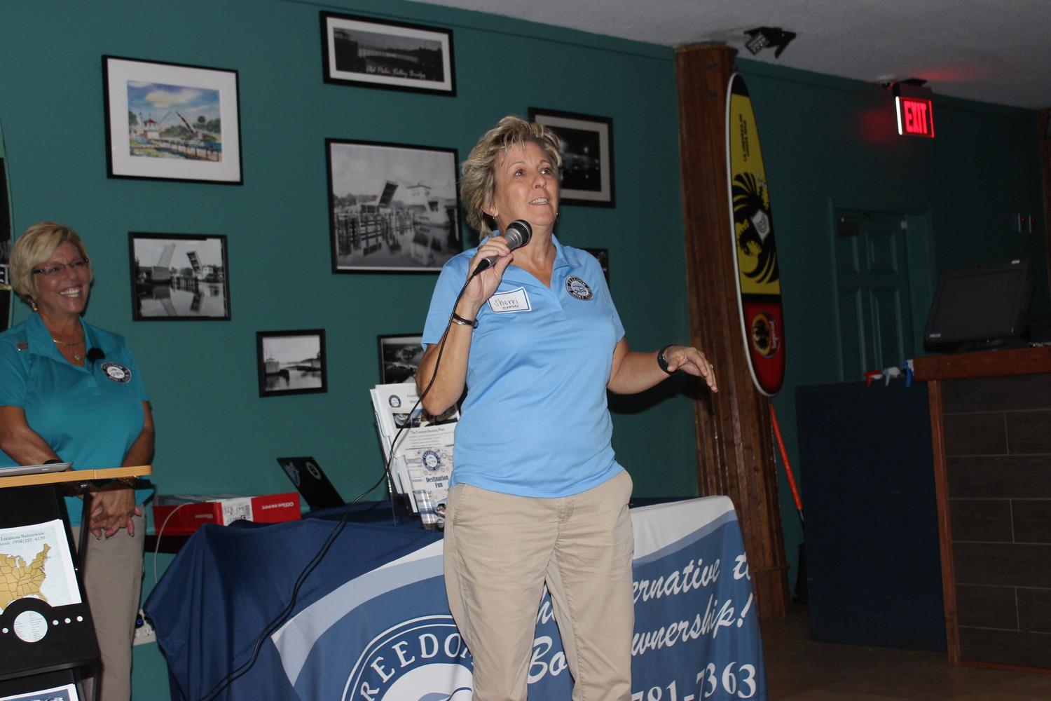 Sherri Anthony delivers a Freedom Boat Club membership testimonial at the Chamber ribbon cutting event.
