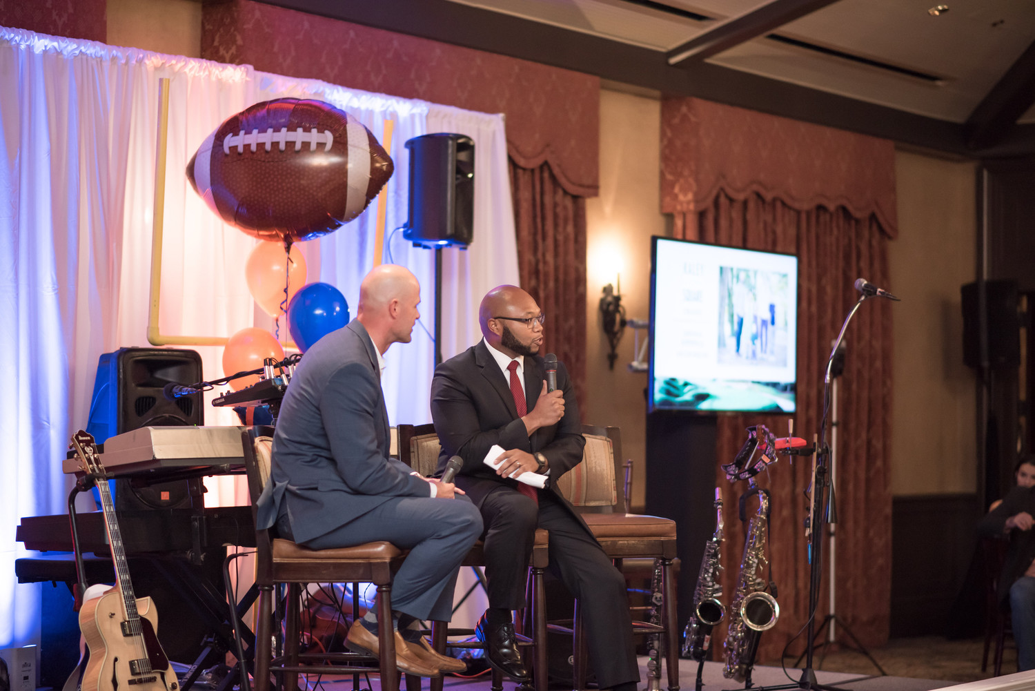 Danny Wuerffel interviews Demetrius Summerville, executive director of Kaley Square in Orlando (Desire Street Ministry partner), during the dinner Thursday evening.