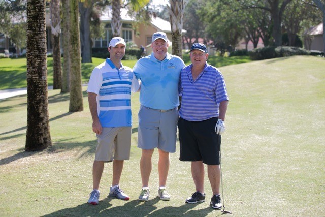 Charles Valenciana, Capt. Sean Haley and Marty Ewing gather during play.