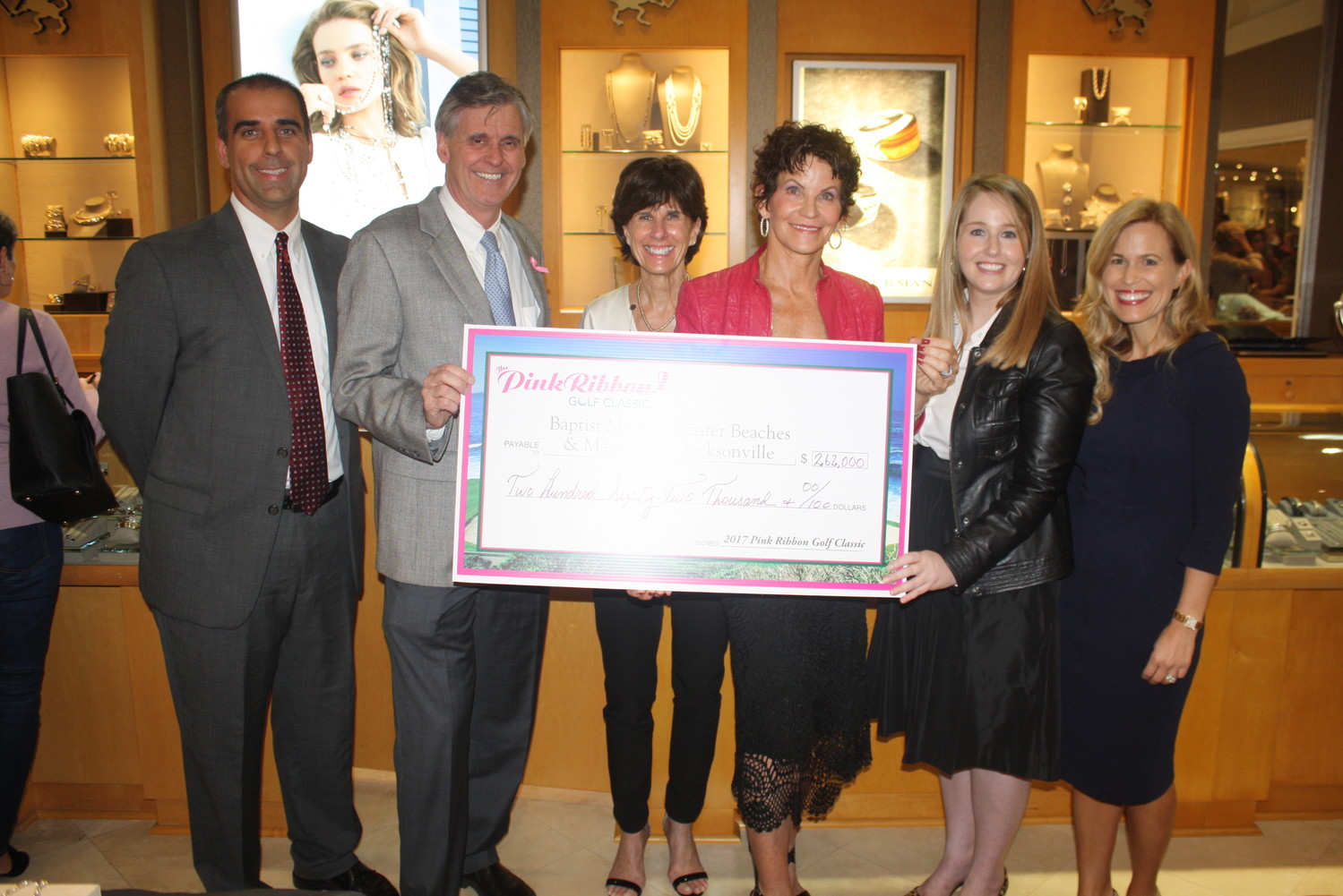Dr. Ryan Makar and Joe Mitrick of Baptist Medical Center Beaches, Pink Ribbon Golf Classic co-chairs Joanne Ghiloni and Nancy Morrison and Jackie Joy and Dr. Dawn Mussallem of Mayo Clinic-Jacksonville display the check total of $262,000, a record amount raised by the Ponte Vedra fundraiser.