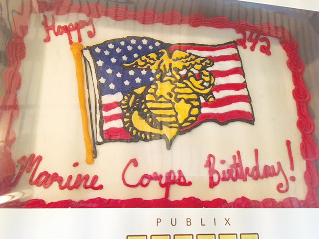 Event attendees enjoy a cake celebrating the 242nd birthday of the U.S. Marine Corps.
