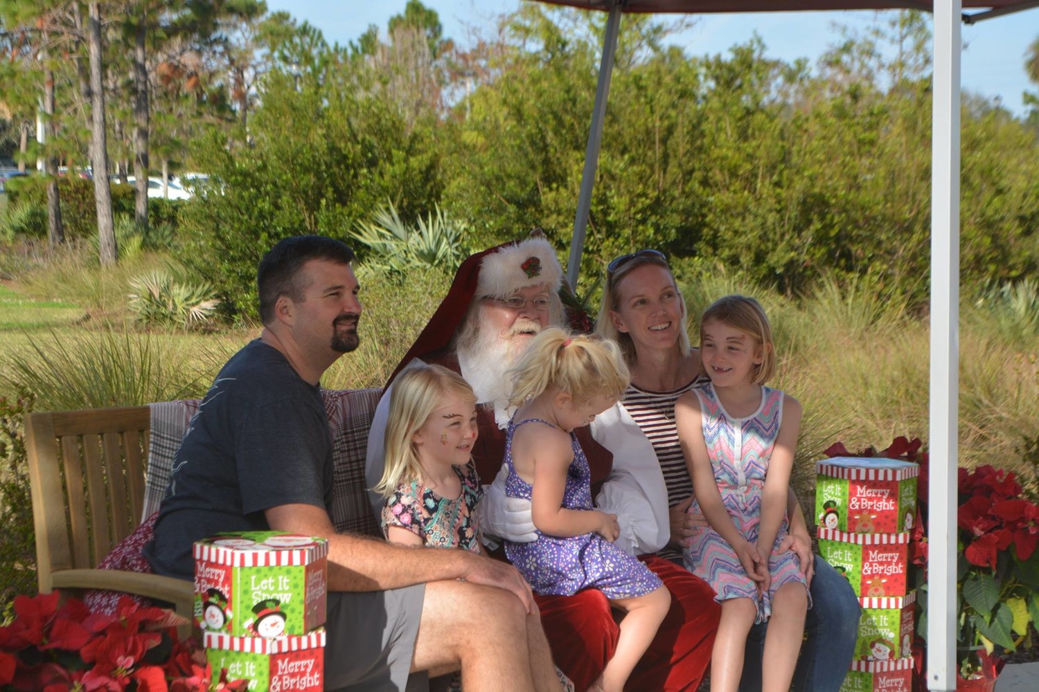 A family poses for pictures with Santa.