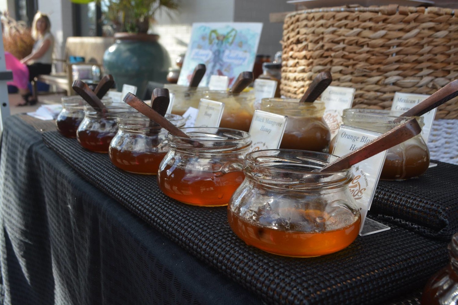 A vendor displays different types of honey at the “Oh What FUN!” Christmas celebration.