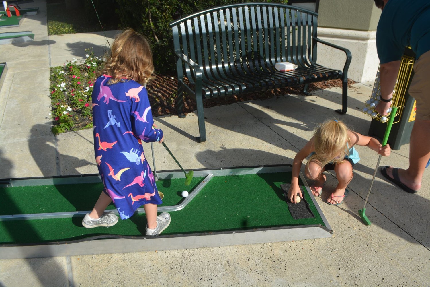Children play mini golf at the “Oh What FUN!” Christmas celebration.