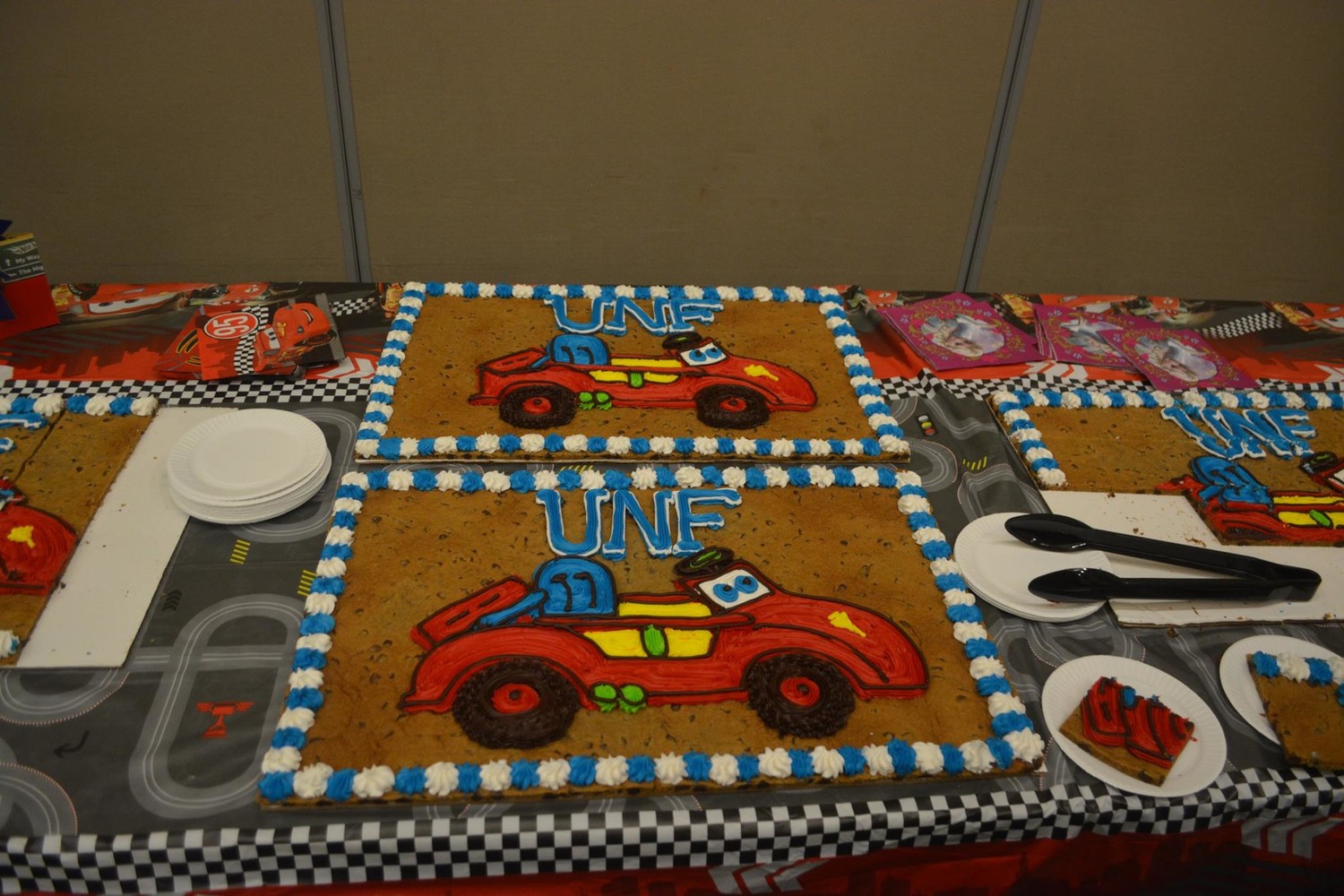 An Adoptive Toy Project-themed cake is displayed at the event.