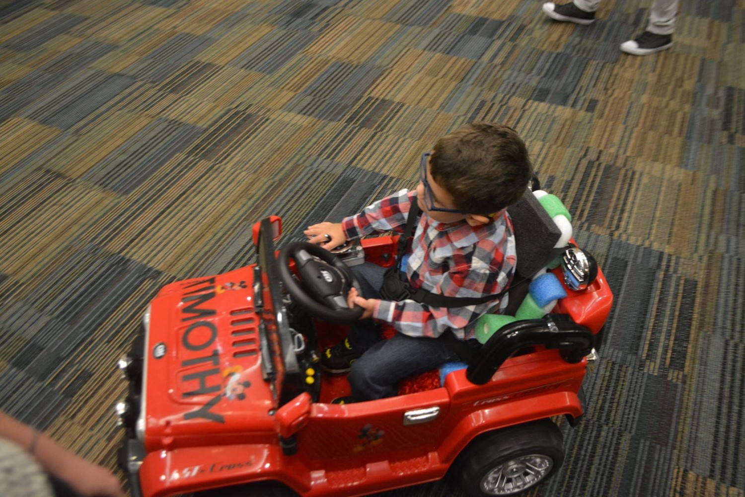 A child drives around in his new car.