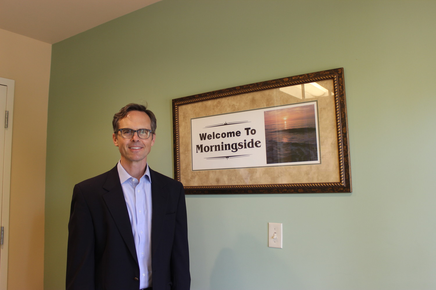 Dr. Todd Snowden stands beside a Morningside photo.