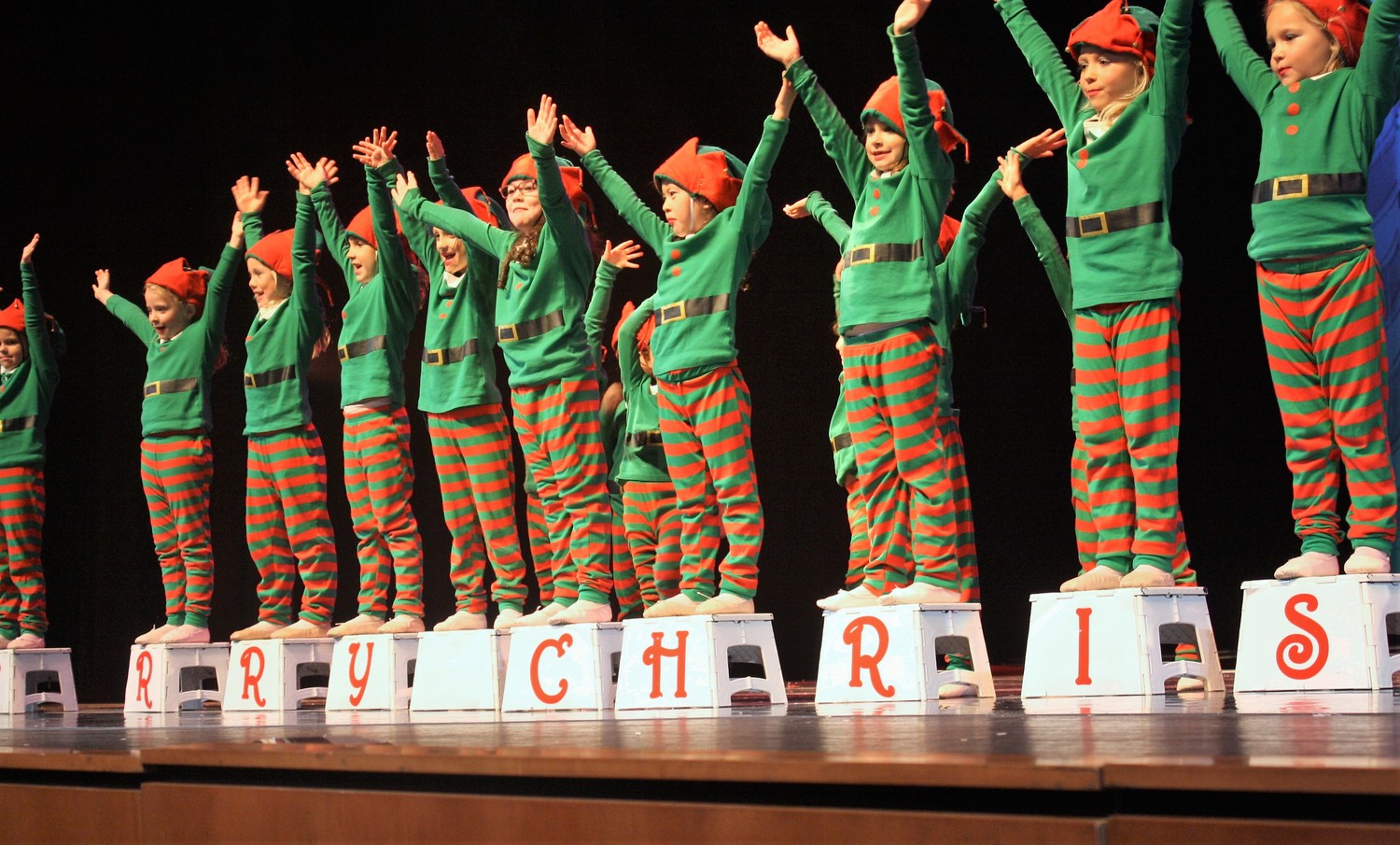 Elves wish the audience a merry Christmas.