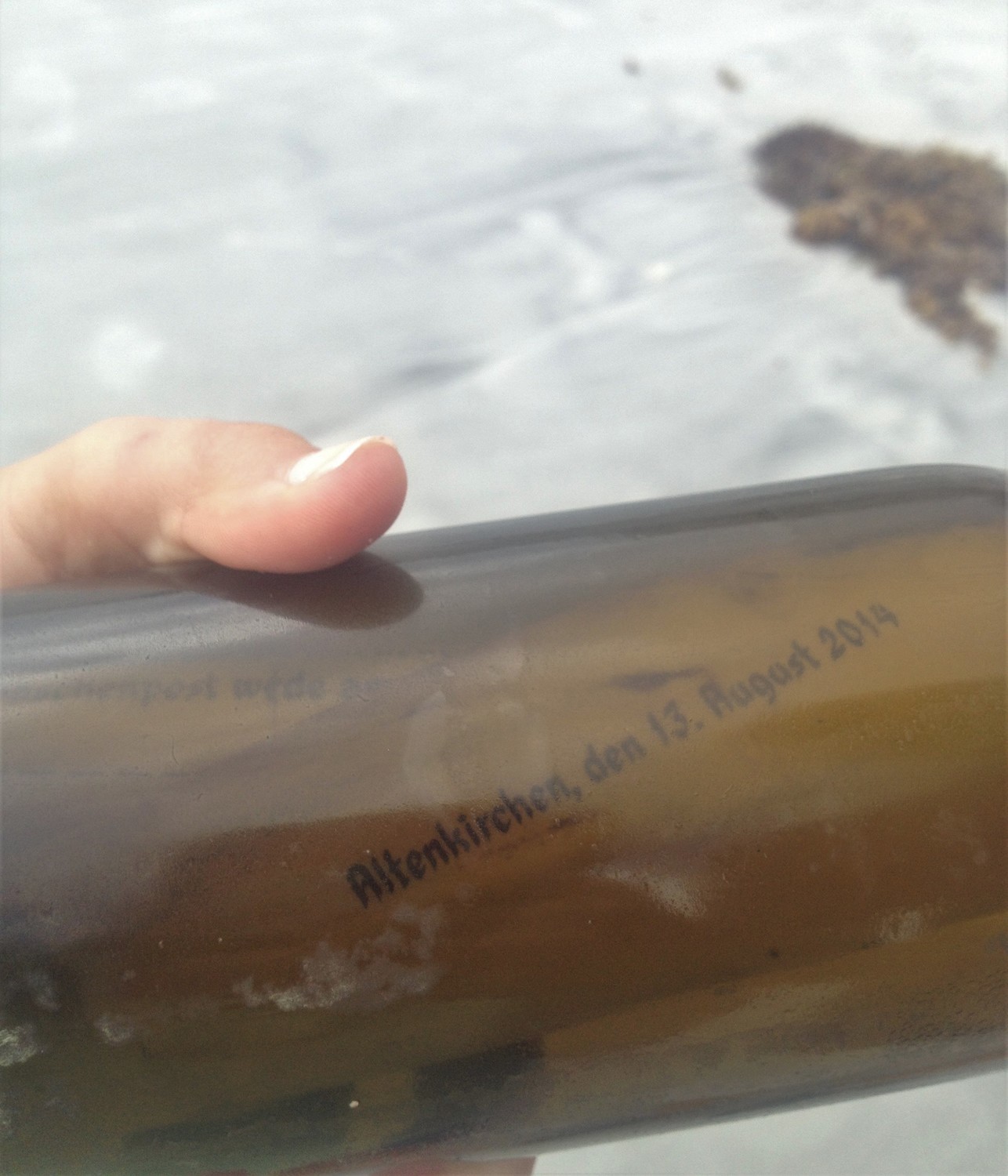 A message, written in German and dated Aug. 13, 2014, is found inside a glass bottle on the beach.