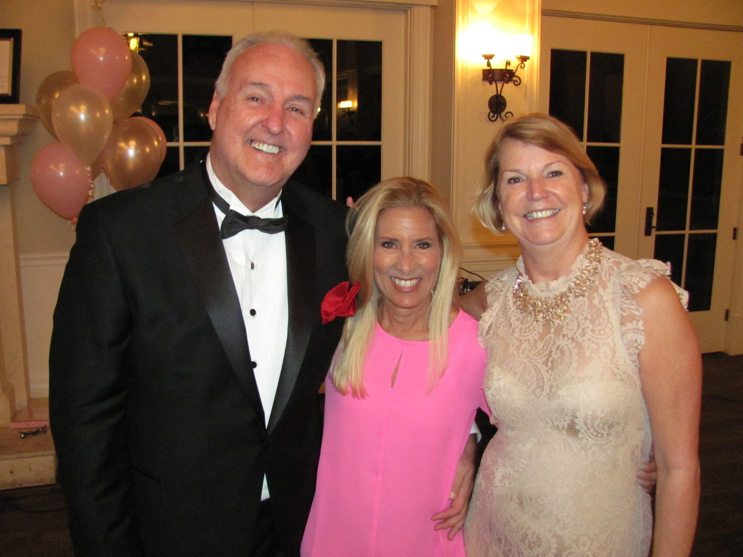 Bill Adams, Donna Deegan and Linda Adams gather at the inaugural “Night of Wine & Roses” last year.