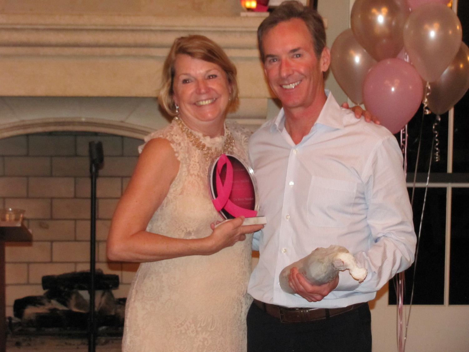 Linda Adams presents the CancerKare’s first “Breasty” award to Ponte Vedra Plastic Surgery’s Dr. Brett Snyder, who performed Linda’s reconstructive surgery following her mastectomy and guided her through aftercare, surgery and recovery