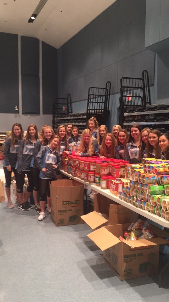 The Ponte Vedra cheerleading team helps Hugs Across the County during the “No Hungry Holidays” food drive.