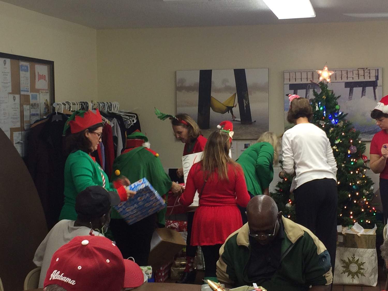 Mission House volunteers pass out presents to awaiting Mission House visitors.
