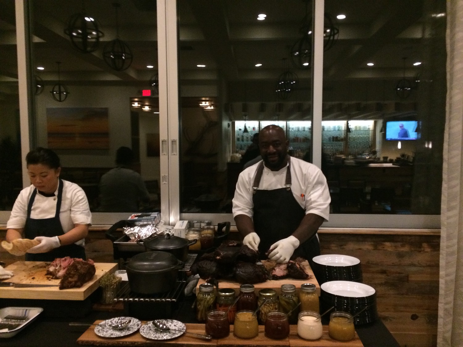 Chef Gilbert prepares a pork dinner at the Southern Kitchen opening preview event.