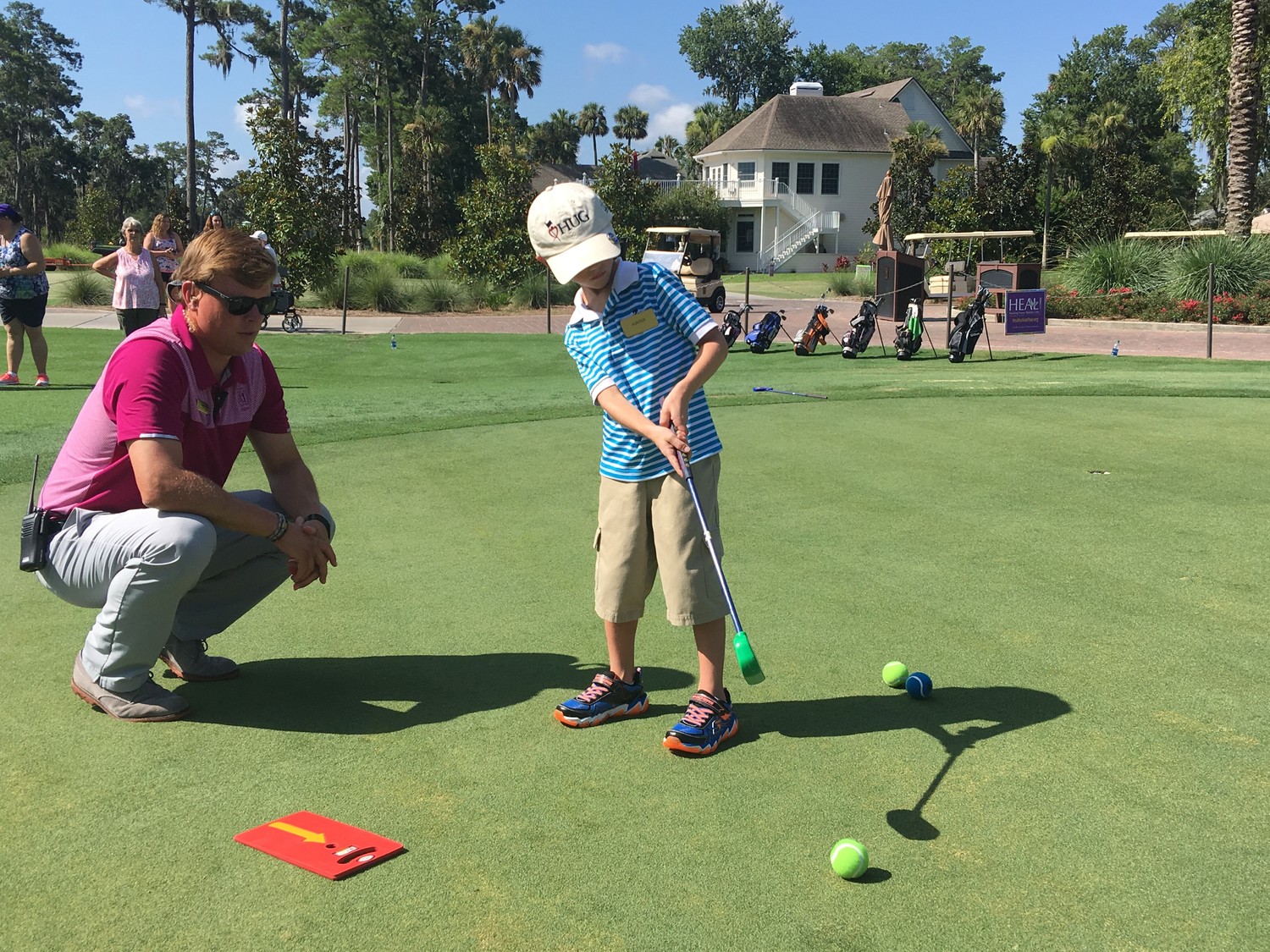 A boy receives golf instruction at the HUG/HEAL Golf Academy at TPC Sawgrass.
