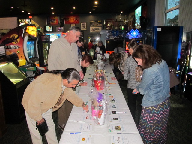 Attendees at a previously held event check out the silent auction items.