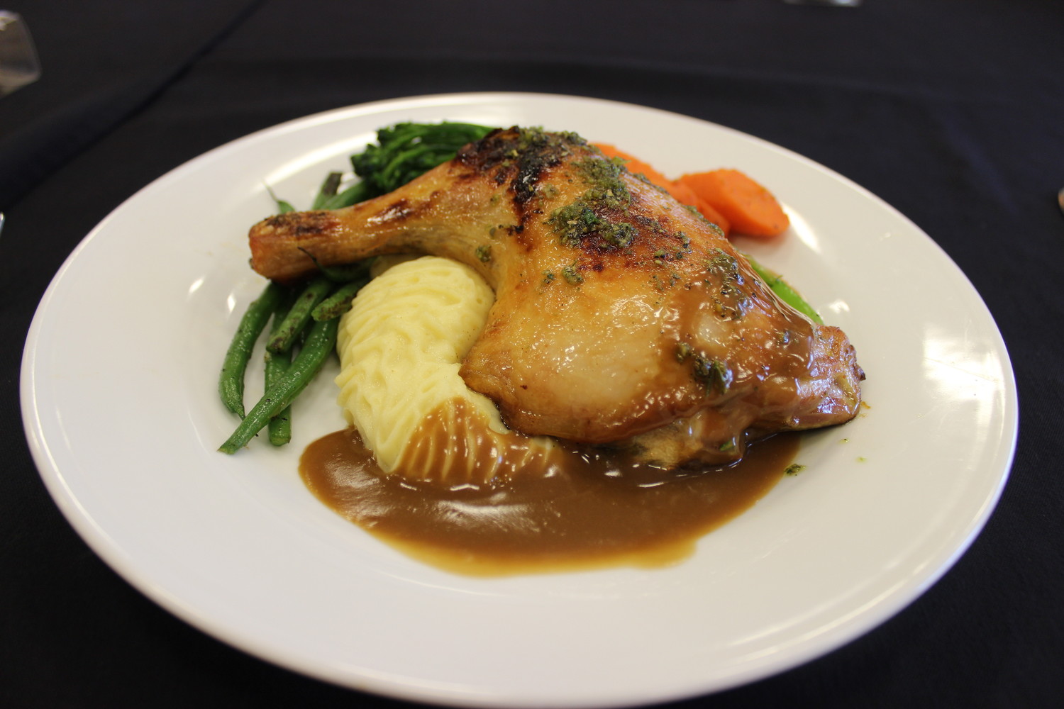 Roasted herb chicken with butter-whipped potatoes and sautéed root vegetables in a veal Brandywine demi glaze, which is an example of the cuisine Sawgrass Events can provide its customers.