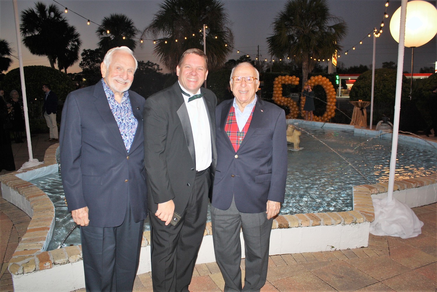 Alhambra Managing Partner Craig Smith (center) stands with former Alhambra owner Ted Johnson (right) and Barry Zisser (left).