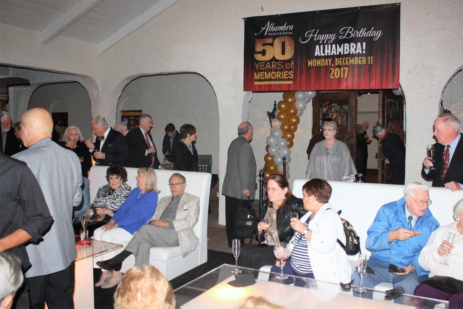 Alhambra patrons sip cocktails and champagne as they celebrate the dinner theatre's 50th anniversary.