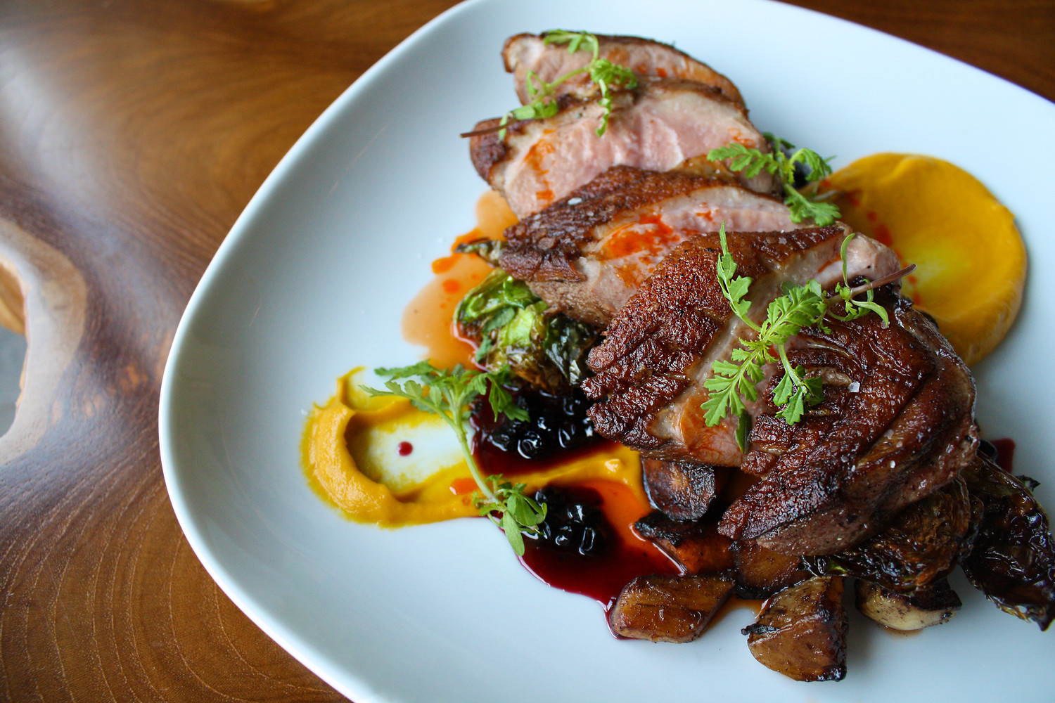 Town Hall’s Duck Breast with crispy Brussels sprouts, roasted root vegetable purée, huckleberry gastrique and paprika oil
